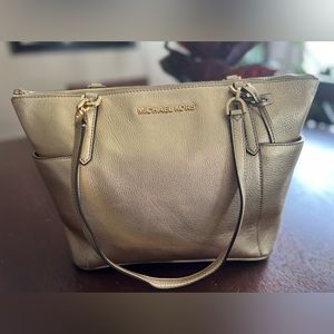 Michael Kors gold handbag.